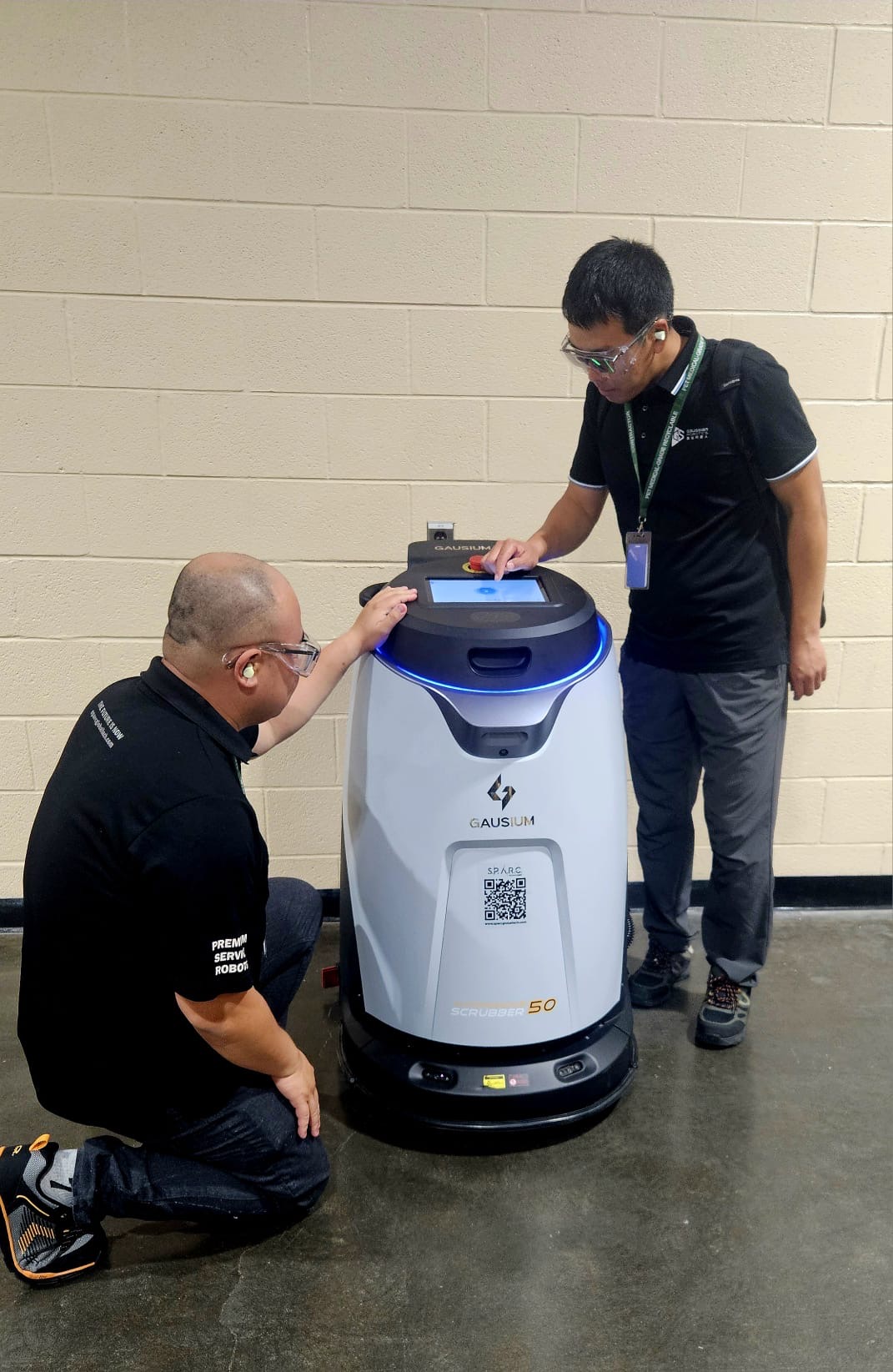 SPARC technician servicing a cleaning robot on site